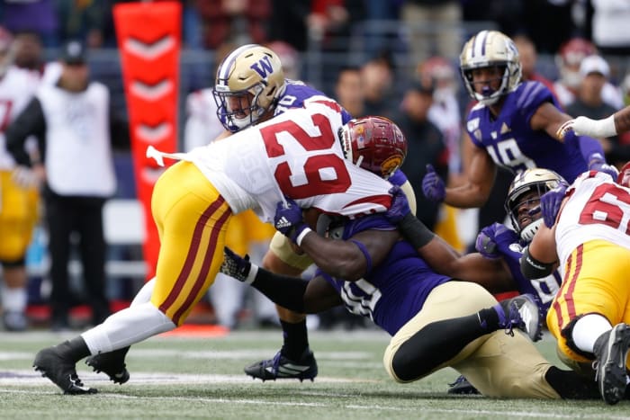 Washington Huskies linebacker Kyler Manu (30), defensive lineman Josiah Bronson (90) combine to stop USC running back Vavae Malepeai (29). Mandatory Credit: Jennifer Buchanan-USA TODAY